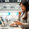 Person comparing different laptop models and specifications